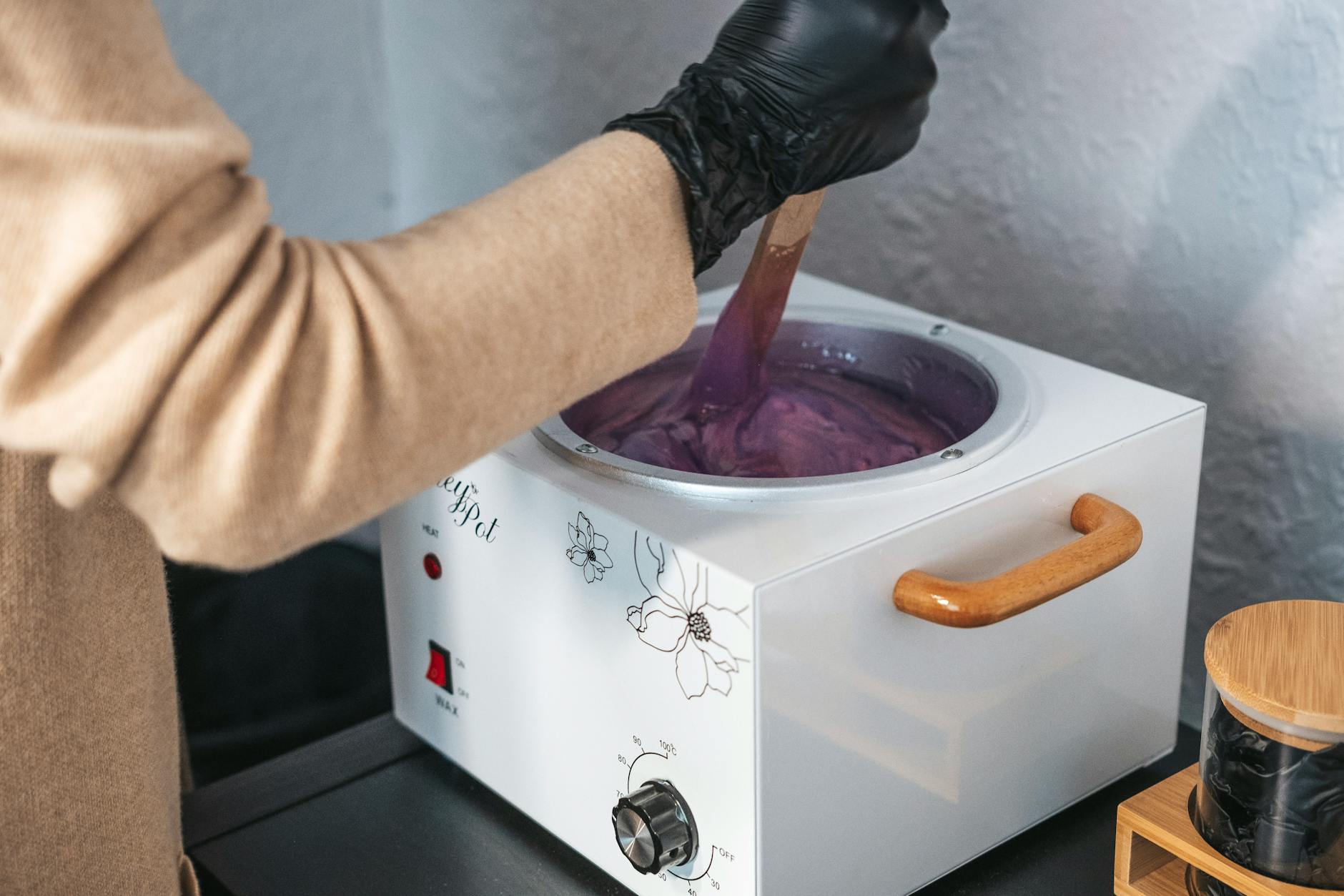 a person is using a purple dye on a pot